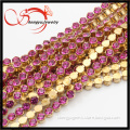 long decorative brass chain with fuchsia crystal